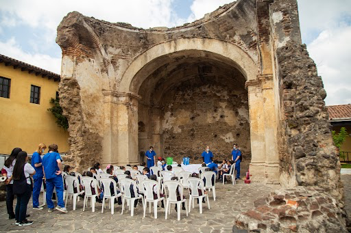 MEDLIFE students gathered inside a colonial stone ruin in Antigua, Guatemala for a mobile clinic