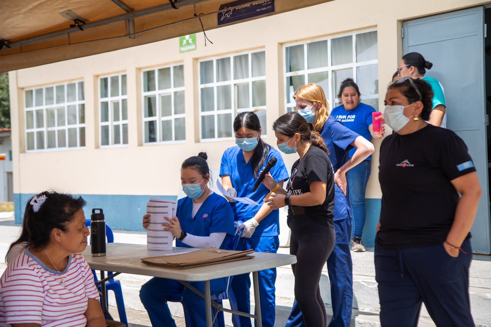 MEDLIFE students and community members gathered at a mobile clinic registration table in Antigua, Guatemala