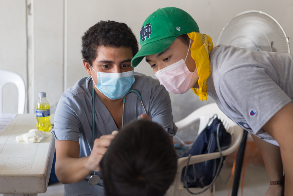 A student observing a mobile clinic consultation in Peru